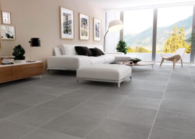 square grey stone concrete floor tiles used in living area with furniture beige outdoor tiles used on wall and floor outside terrace from from design di lusso watford tile shop